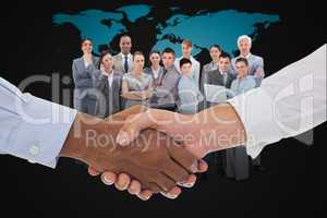 Composite image of close-up shot of a handshake in office