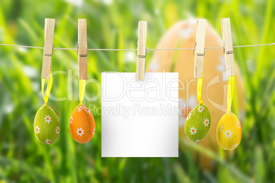 Composite image of hanging easter eggs