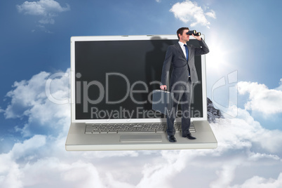 Composite image of businessman looking through binoculars