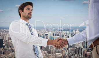 Composite image of two businessmen shaking hands in office