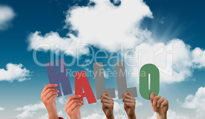 Composite image of hands holding up hallo