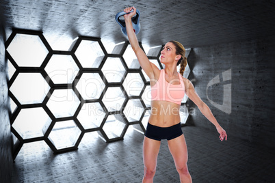 Composite image of female crossfitter lifting up kettlebell