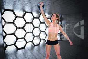 Composite image of female crossfitter lifting up kettlebell