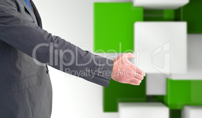 Composite image of businessman holding his hand out