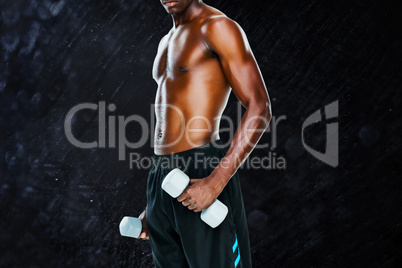 Composite image of mid section of fit shirtless man lifting dumb
