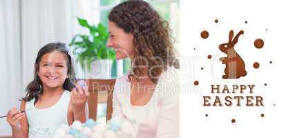 Composite image of happy mother and daughter painting easter egg