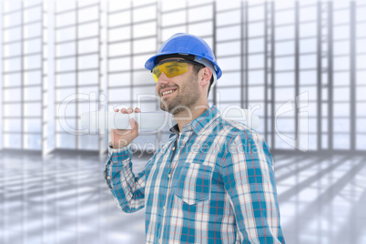 Composite image of smiling architect looking away while holding