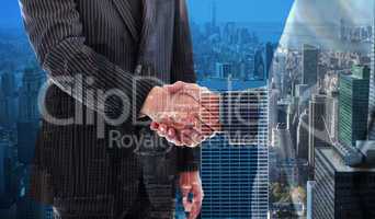 Composite image of business people shaking hands