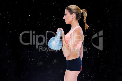 Composite image of female blonde crossfitter lifting kettlebell