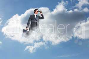 Composite image of businessman looking through binoculars