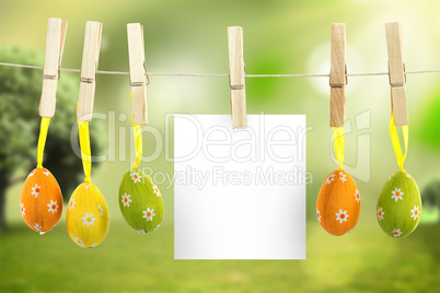 Composite image of hanging easter eggs