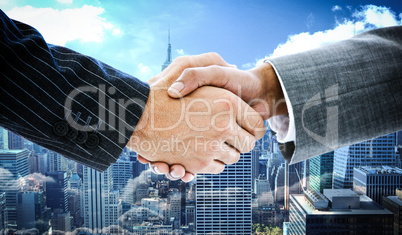 Composite image of business people shaking hands