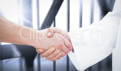 Composite image of closeup of a doctor and patient shaking hands