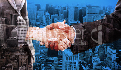 Composite image of close up of two businesspeople shaking their