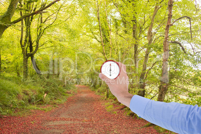 Composite image of businessman holding hand out in presentation