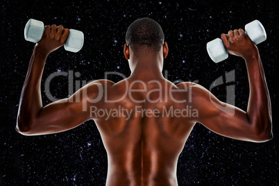 Composite image of rear view of a fit shirtless man lifting dumb