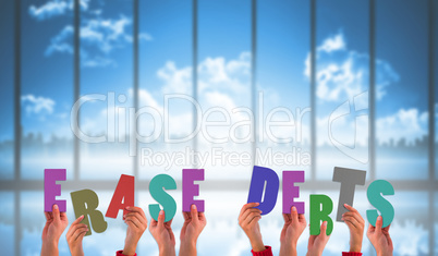 Composite image of hands holding up erase debts