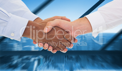 Composite image of close-up shot of a handshake in office