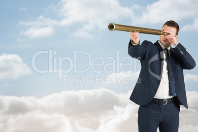 Composite image of businessman looking through telescope