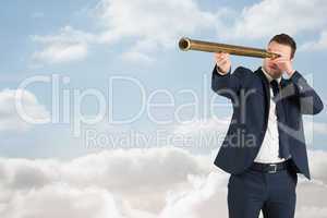 Composite image of businessman looking through telescope