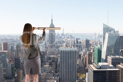 Composite image of businesswoman looking through a telescope