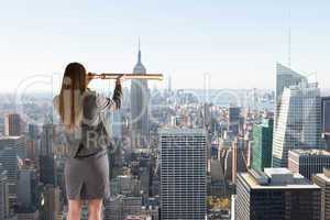 Composite image of businesswoman looking through a telescope