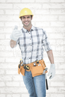 Composite image of male handyman gesturing thumbs up sign