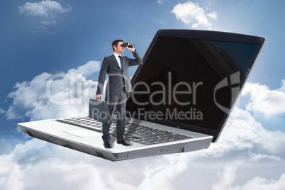 Composite image of businessman looking through binoculars