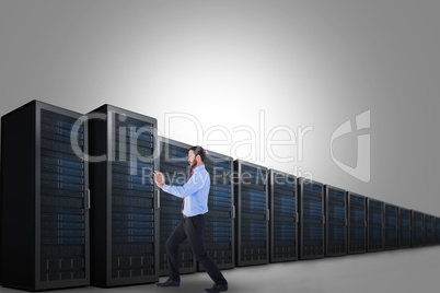 Composite image of focused businessman standing and pushing with