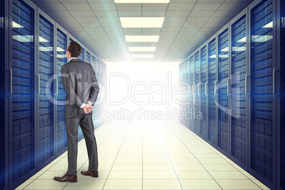 Composite image of businessman in grey suit looking