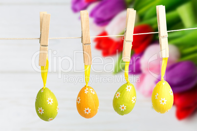 Composite image of hanging easter eggs