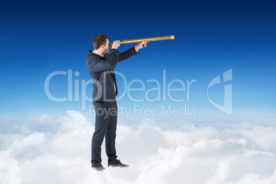 Composite image of businessman looking through telescope