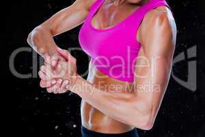 Composite image of female bodybuilder flexing mid section