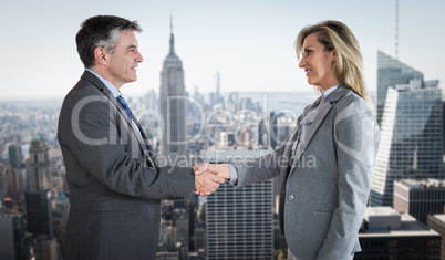 Composite image of pleased businessman shaking the hand of conte