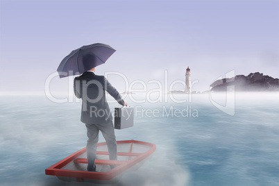 Composite image of businessman in boat with umbrella