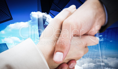 Composite image of close up on new partners shaking hands