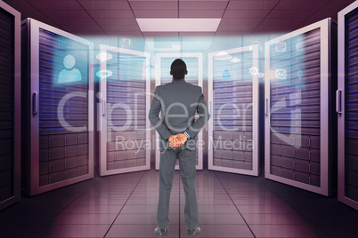 Composite image of young businessman standing with hands behind