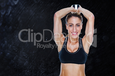 Composite image of female happy bodybuilder working out with lar