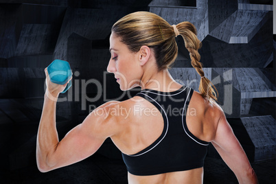 Composite image of female bodybuilder holding a dumbbell