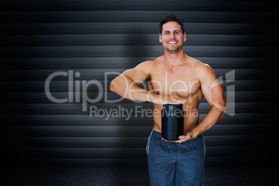 Composite image of bodybuilder with protein powder