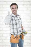 Composite image of happy handyman gesturing thumbs up