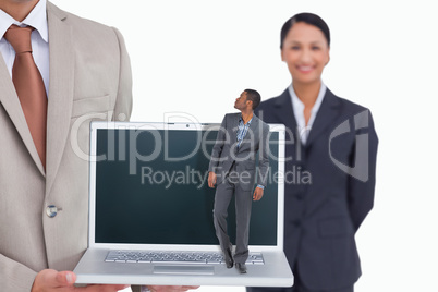 Composite image of businessman standing and looking