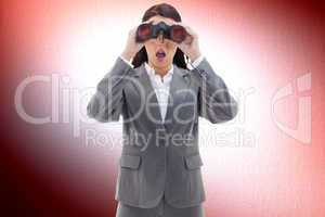 Composite image of surprised businesswoman looking through binoc