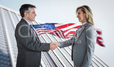 Composite image of pleased businessman shaking the hand of conte