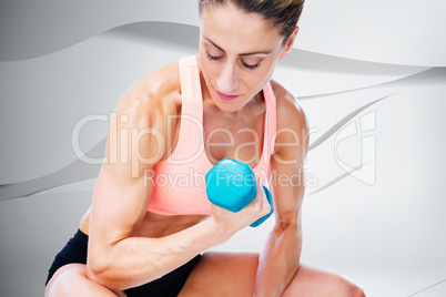 Composite image of strong woman doing bicep curl with blue dumbb