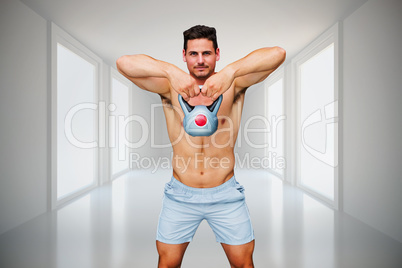 Composite image of bodybuilder holding kettlebell