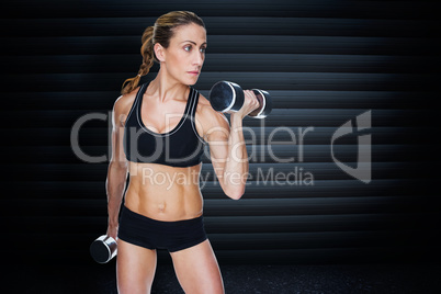 Composite image of female bodybuilder working out with large dum