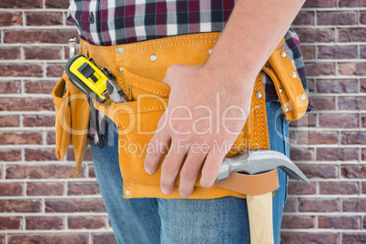 Composite image of close-up of male repairman wearing tool belt
