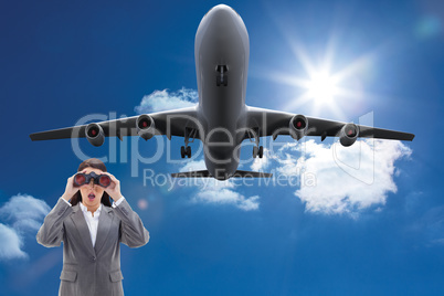 Composite image of surprised businesswoman looking through binoc