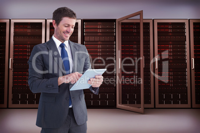 Composite image of businessman using his tablet pc